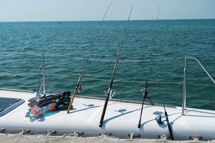 Fishing gear and snorkel fins on the deck of a private yacht