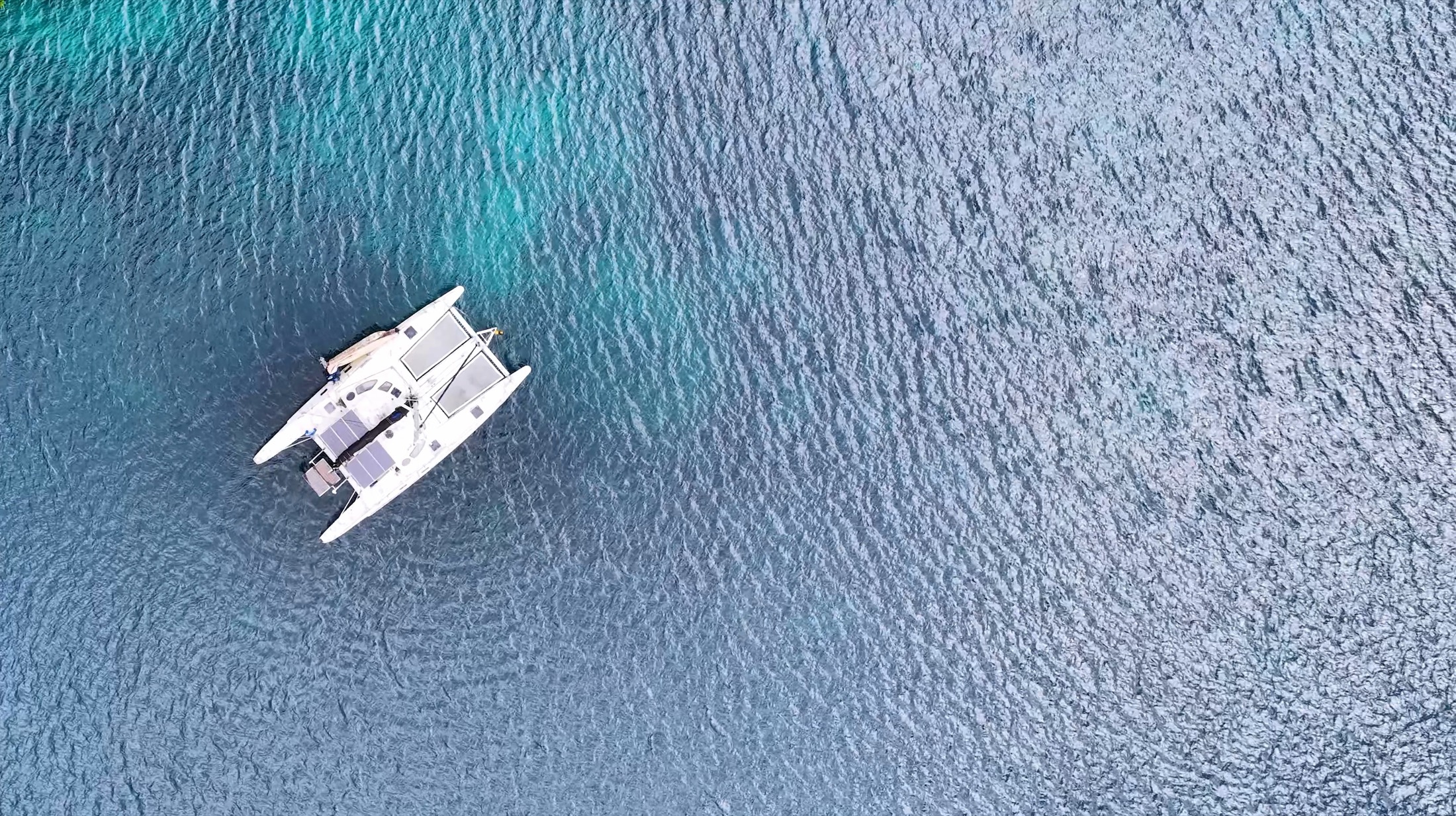 Yacht anchored in clear turquoise water