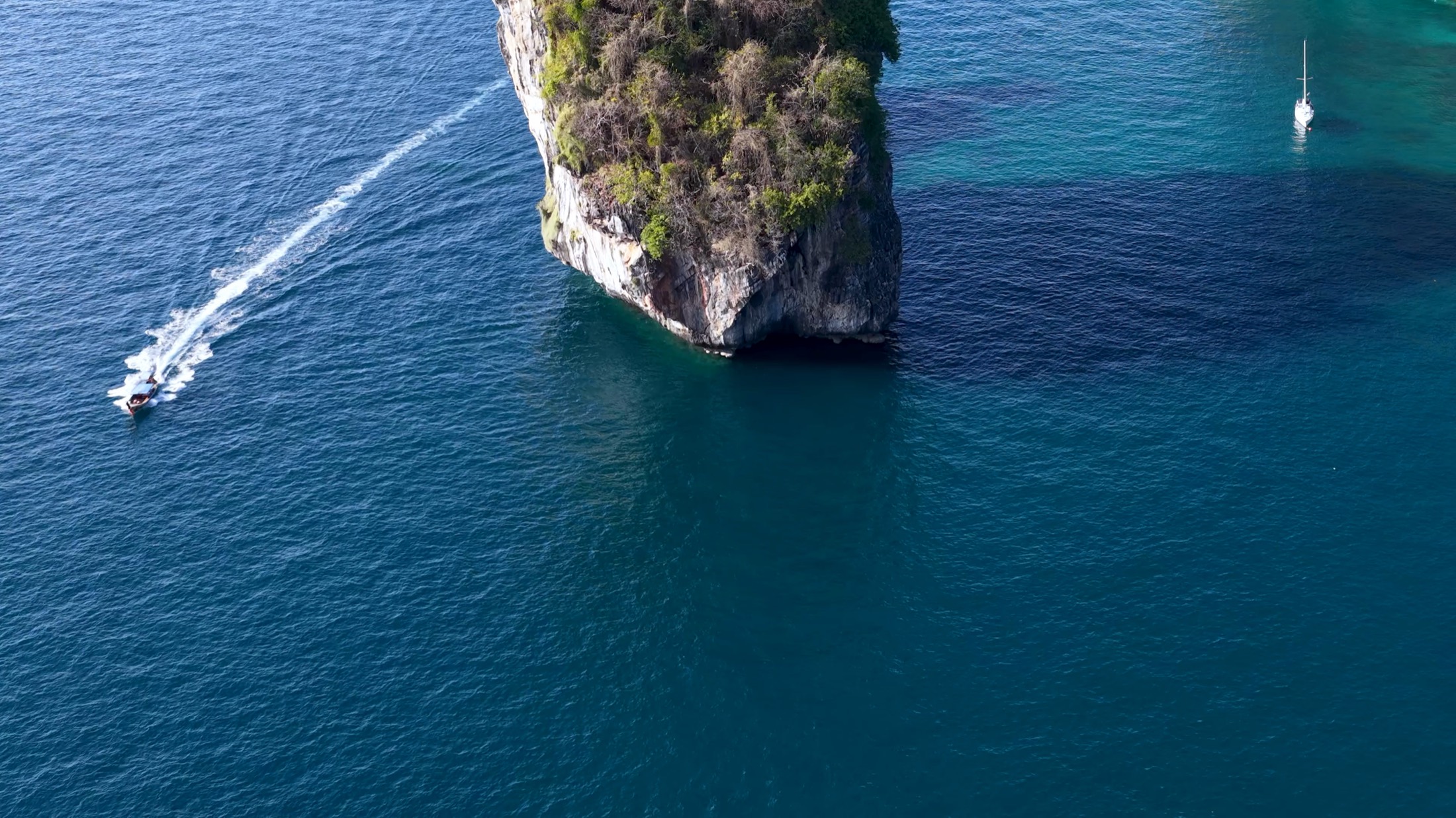 Limestone island and anchored boats in Thailand