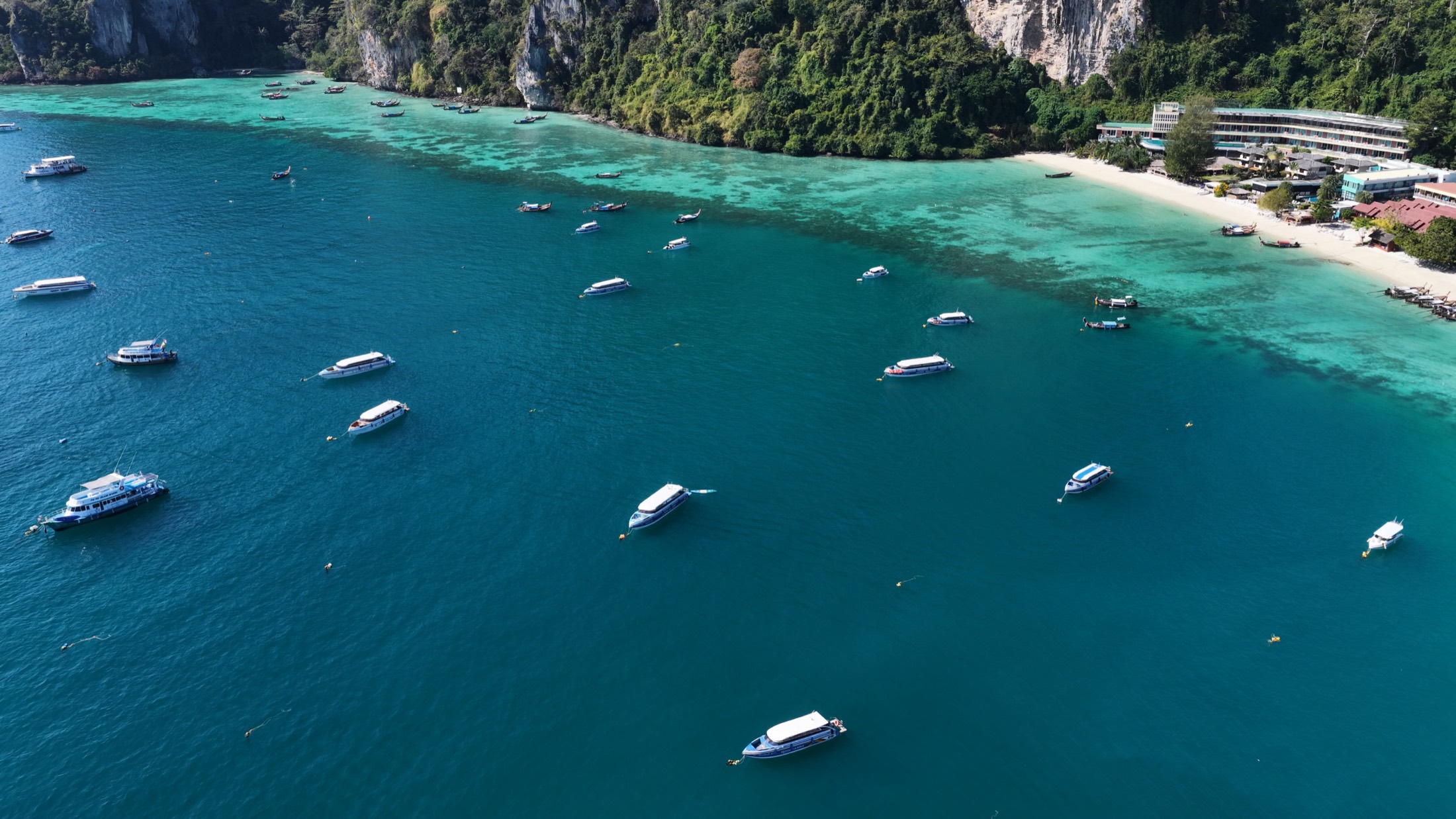 Boats anchored in turquoise island water