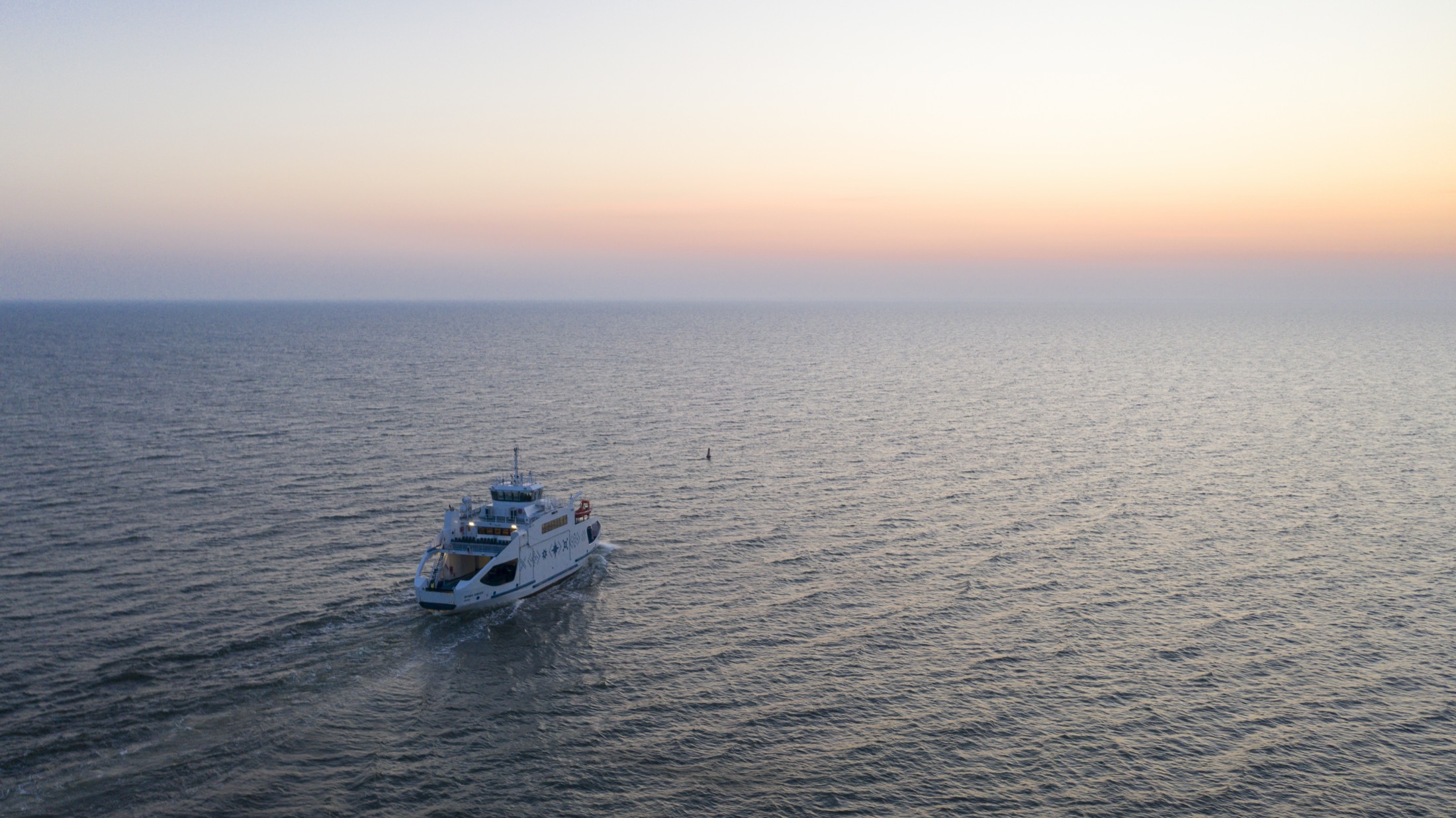 Yacht sailing in golden sunset water